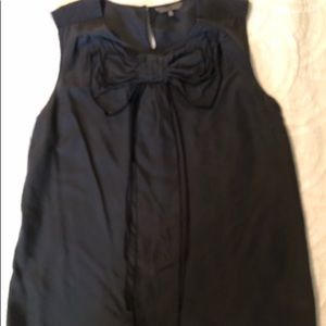 Sleeveless black blouse with bow detail